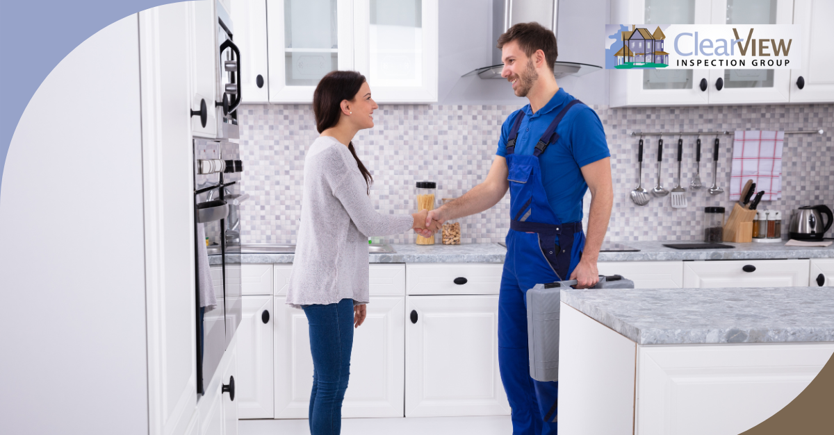 Home inspector greeting homeowner in modern kitchen.